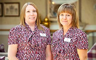 Two smiling staff members at Beaumont Manor Care Home