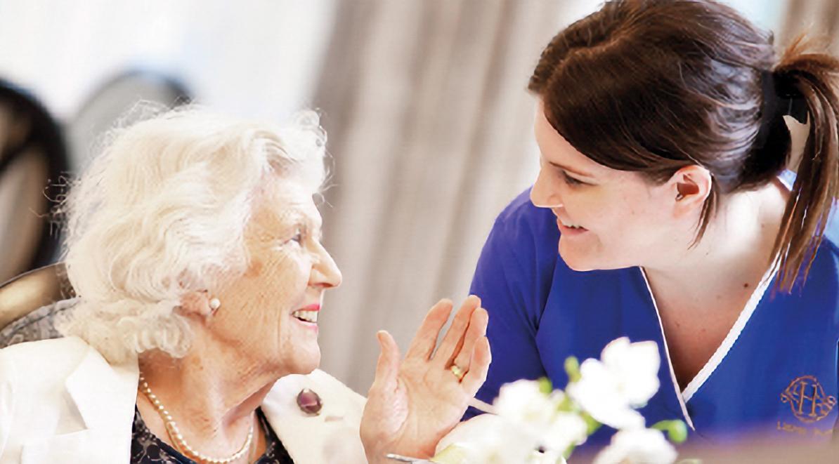 resident and carer smiling at each other