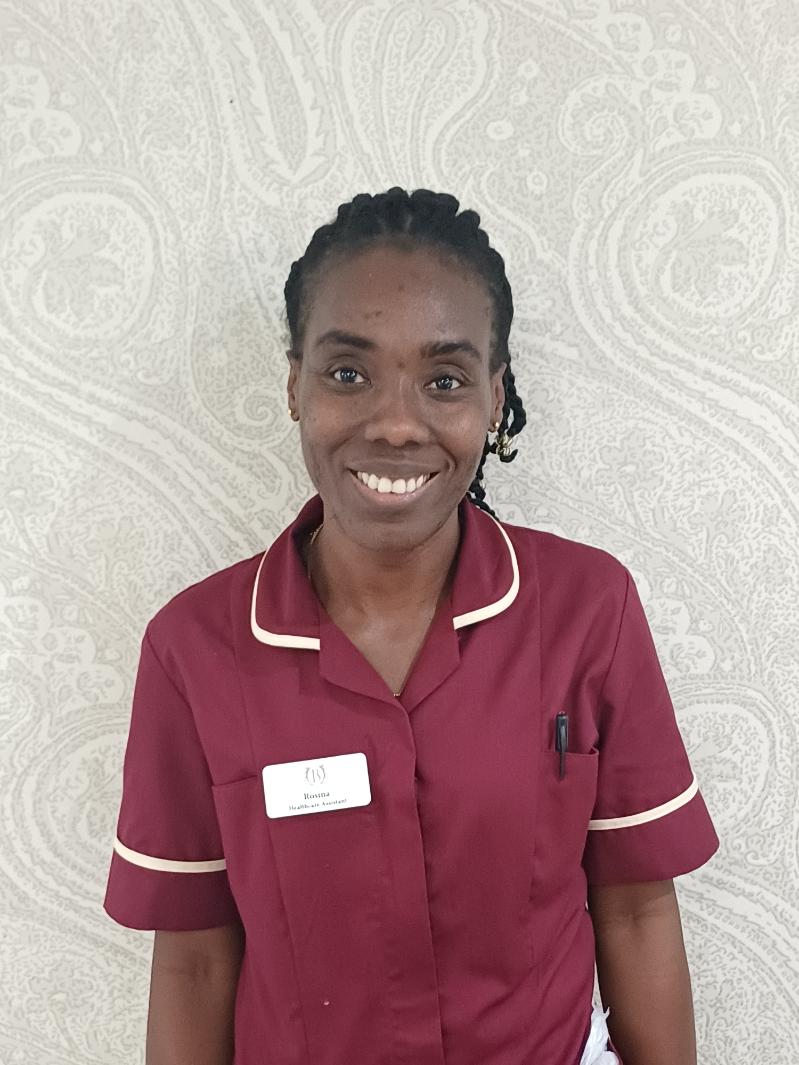 lady in red shirt smiling at camera for staff photo